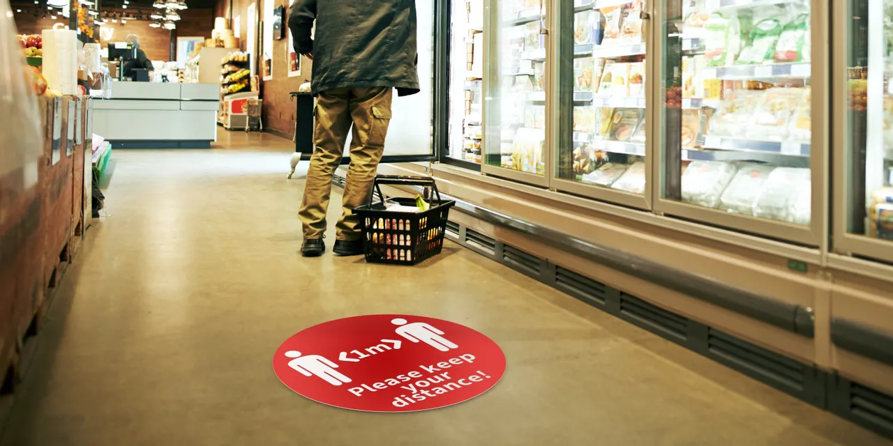 Trotec laser-cut floor sticker in grocery store promoting social distancing
