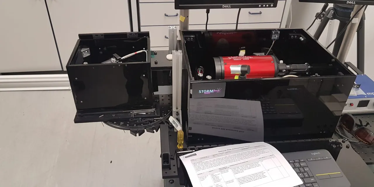 STORM laser marking system with red laser module and control monitors in laboratory setup
