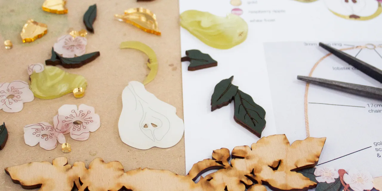 Laser-cut wooden pear tree necklace pieces made with Trotec Speedy laser engraver and assembly guide