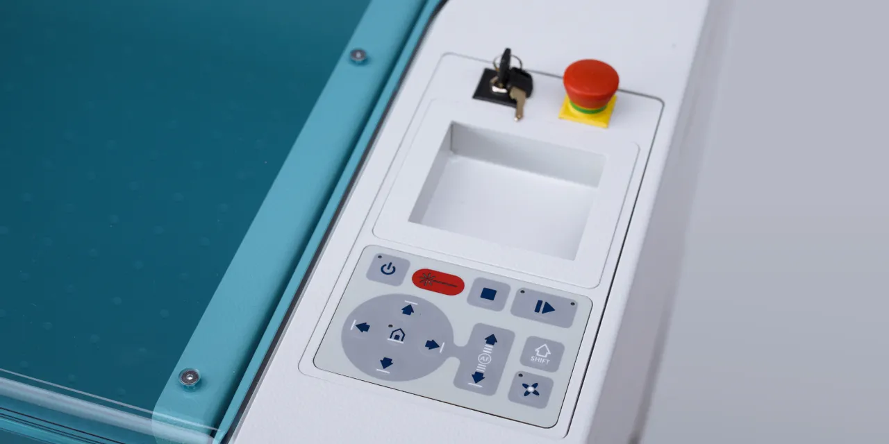 Control panel of Trotec Speedy series CO₂ laser cutter with emergency stop and key switch