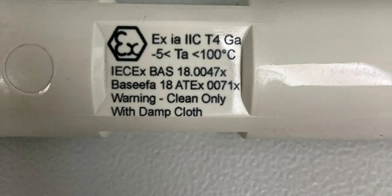 Close-up of IECEx certified device label showing electrical safety and cleaning instructions