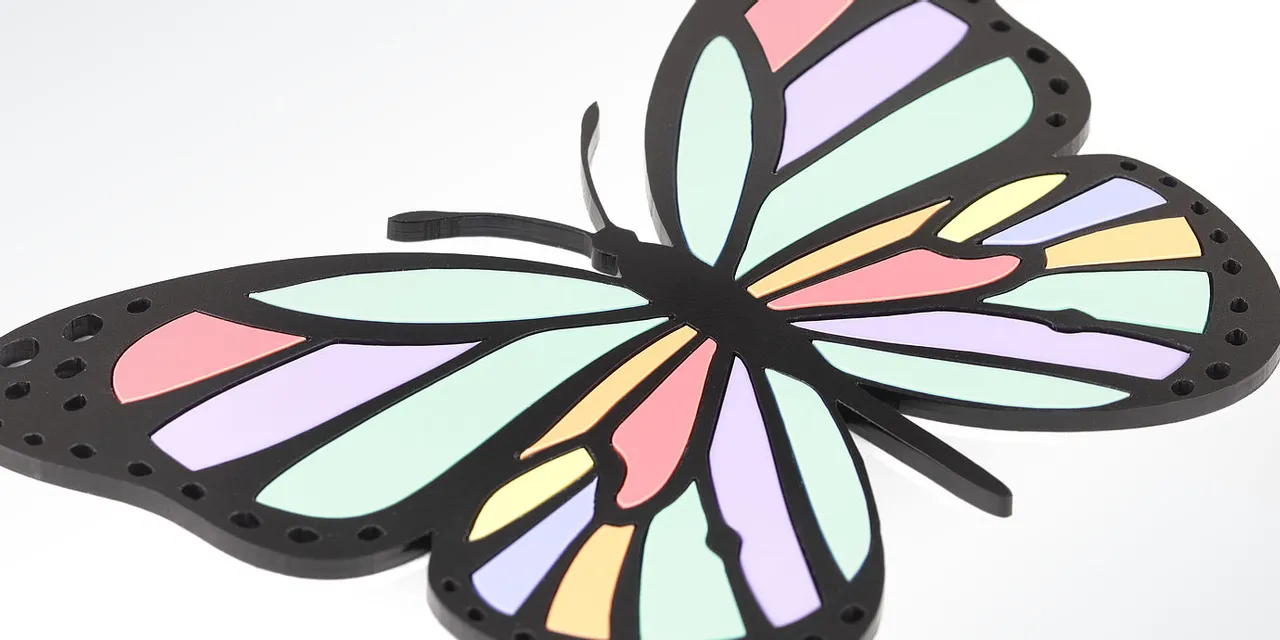 Colorful butterfly shape cut from acrylic using Trotec Speedy series laser cutter