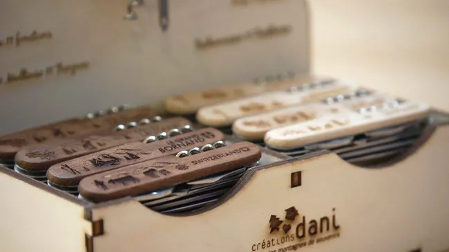 Wooden knives engraved with Trotec laser cutter showcasing detailed Swiss-themed designs