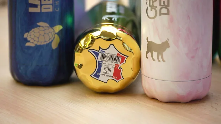 Laser-engraved metal bottles with animal designs created using Trotec CO₂ laser marking technology