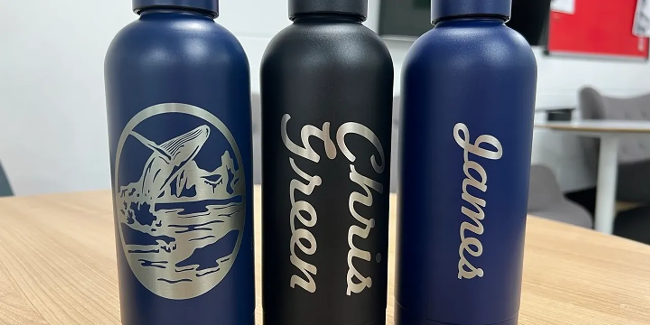 Customized metal bottles engraved with Trotec laser cutter, featuring names and whale design