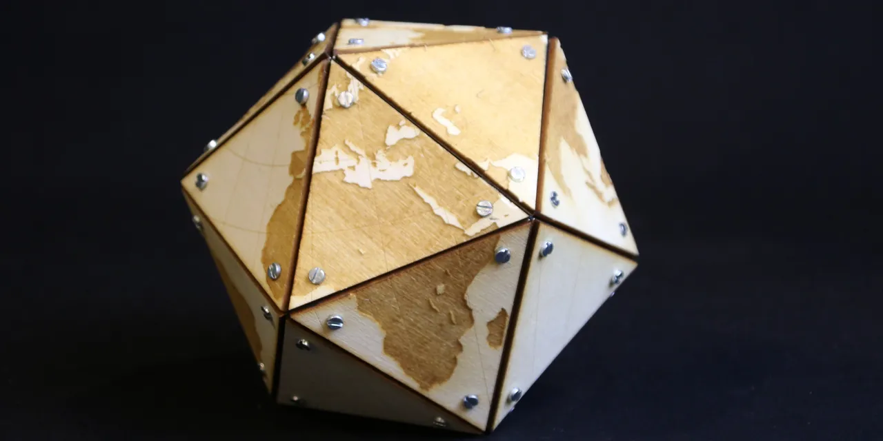 Geometric wooden globe with engraved continents made using Trotec CO₂ laser cutter