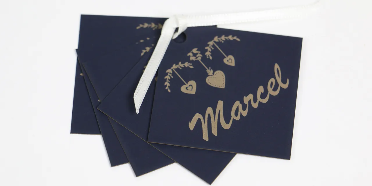 Laser-engraved navy gift tags with name Marcel created using Trotec laser cutter