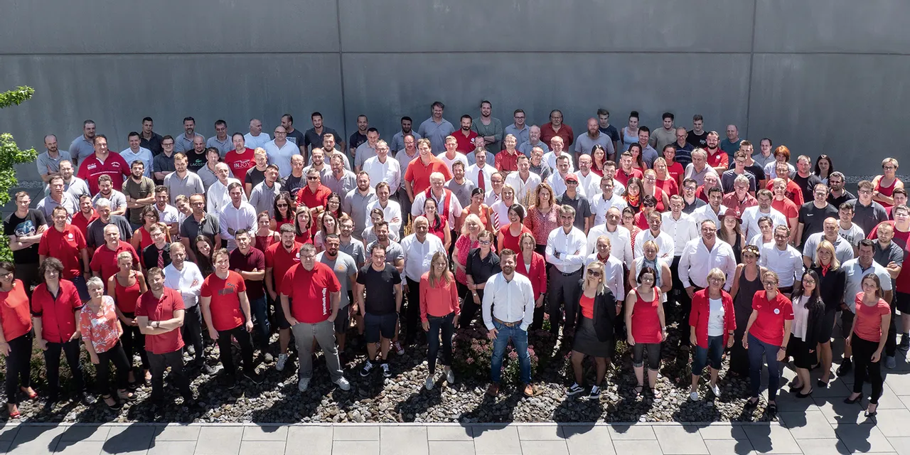 Large group of Trotec team members gathered outside corporate headquarters