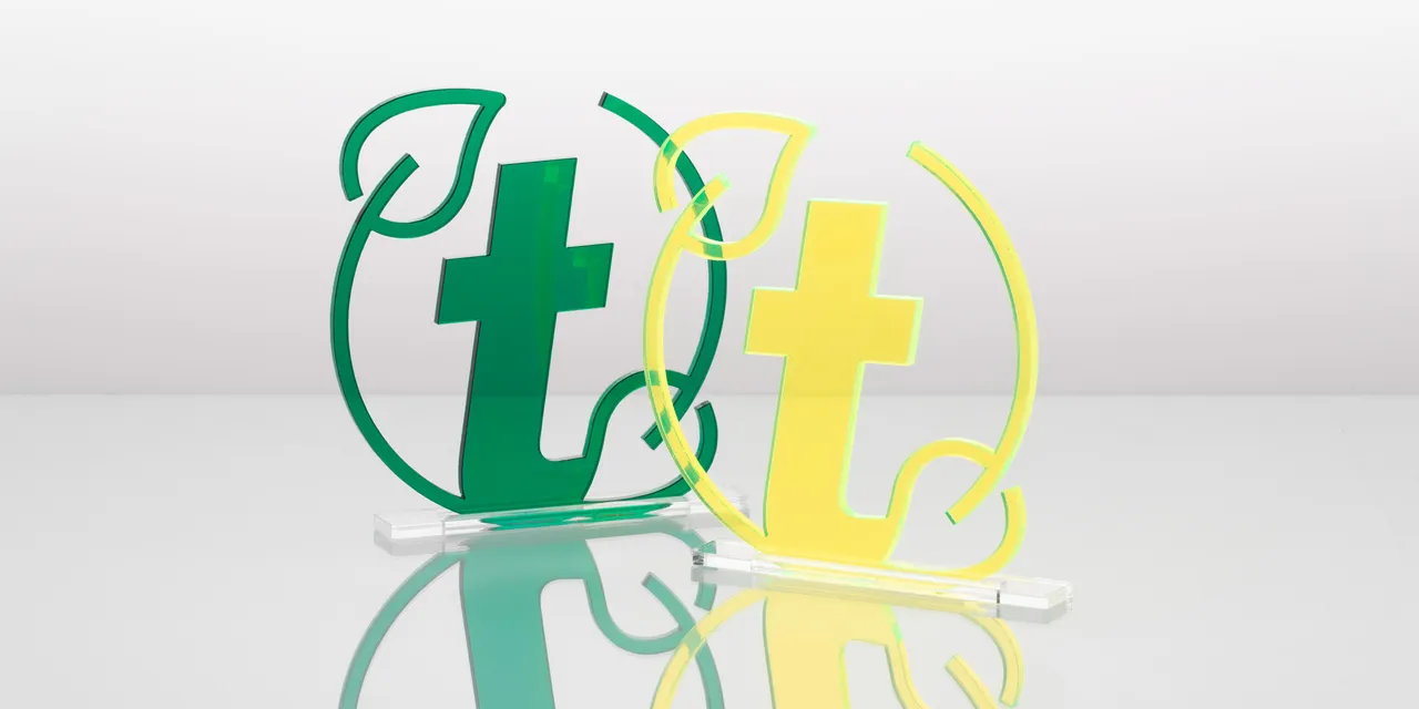 Laser-cut acrylic Trotec logo signs in green and yellow using Trotec Speedy series CO₂ laser