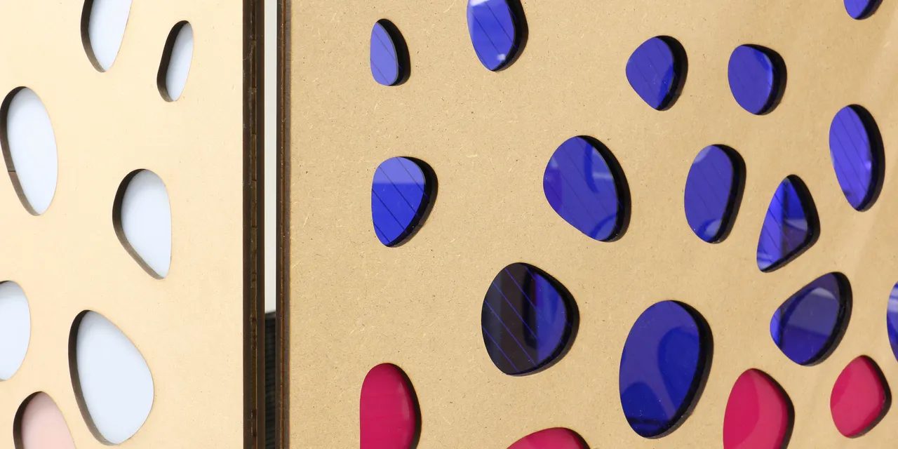 Laser-cut MDF panels with colorful acrylic inlays made using Trotec laser cutter