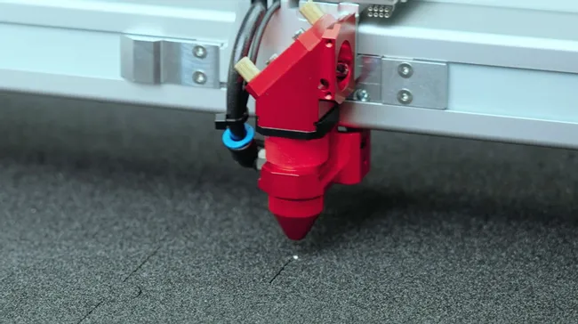 Trotec laser cutter head engraving black foam with precision CO₂ laser technology