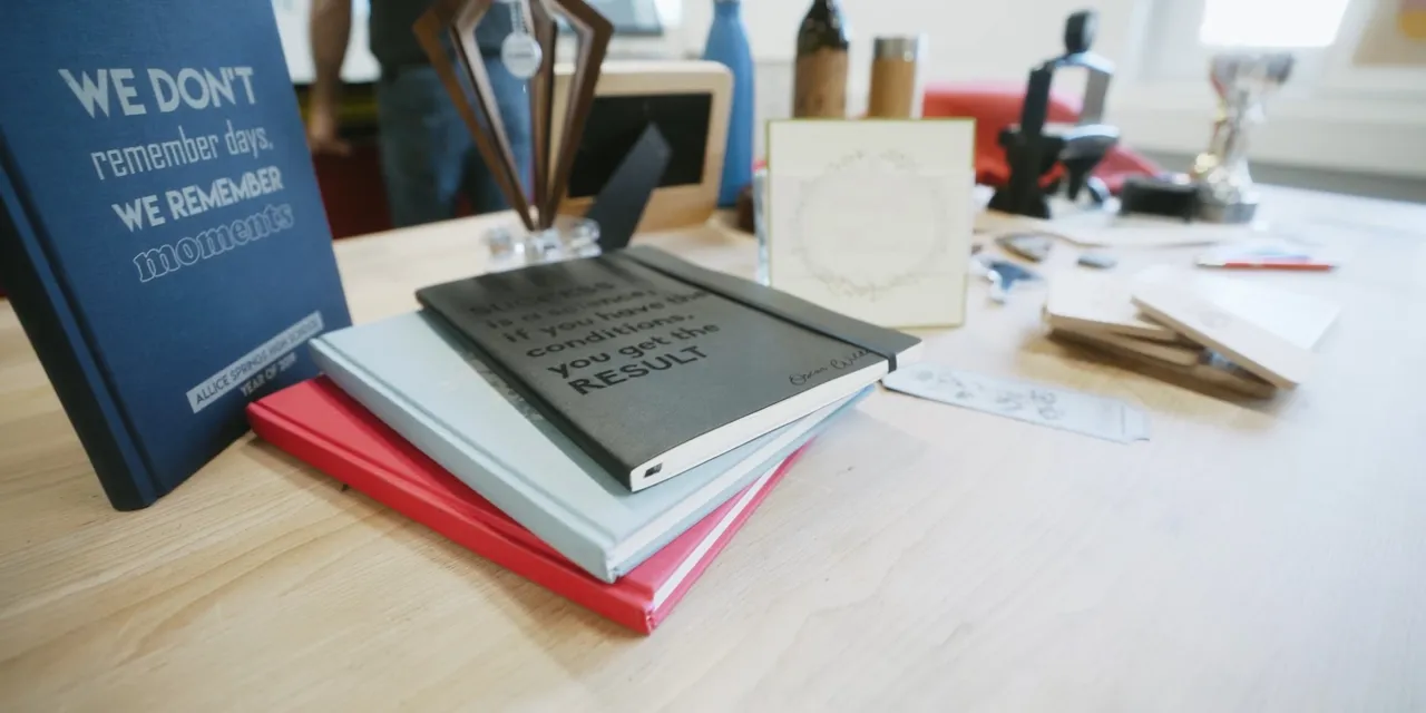 Laser-engraved notebooks and gifts made with Trotec CO₂ laser cutter on wooden table