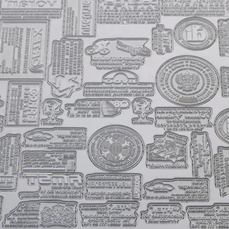 Laser-engraved rubber stamps created with Trotec laser cutter showing detailed text and logo designs