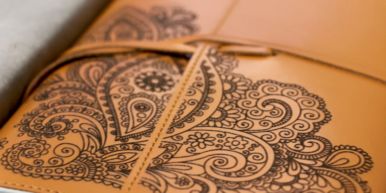 Leather notebook cover with detailed paisley design engraved using Trotec laser cutter
