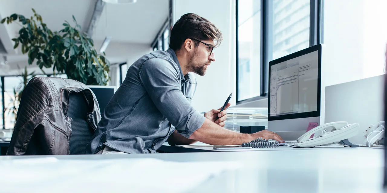 Man using Trotec Ruby software on desktop computer in modern office