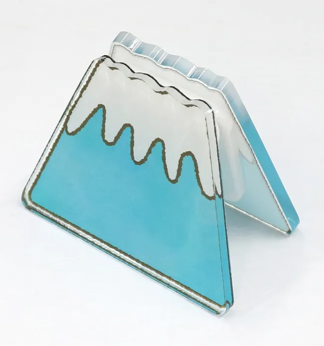 Acrylic mountain-shaped piece with snowcap design cut using Trotec laser cutter