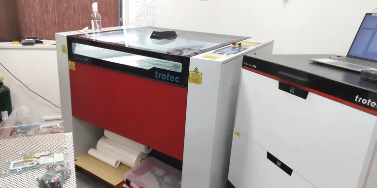 Trotec Speedy 360 CO₂ laser engraver with Atmos Pure 600 exhaust system in workshop setup