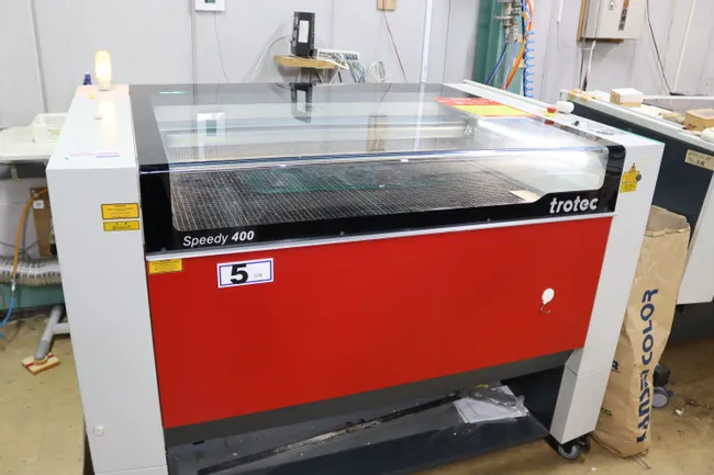 Trotec Speedy 400 CO₂ laser cutter and engraver in workshop setting