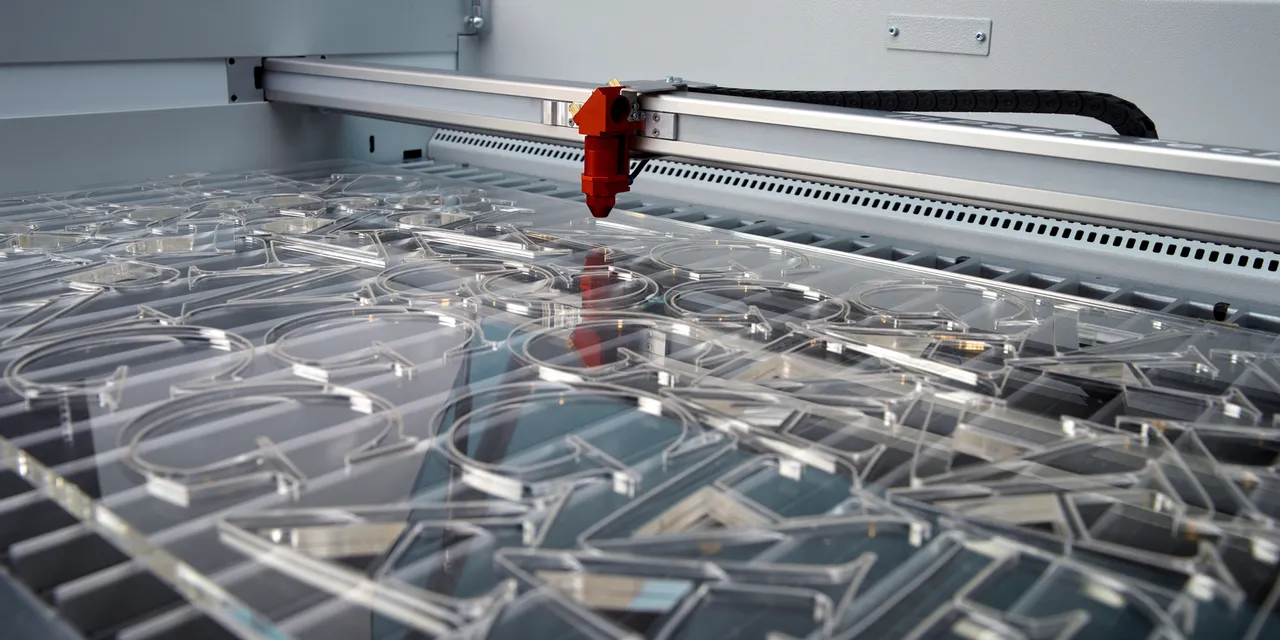 Trotec laser cutter engraving clear acrylic letters with precision
