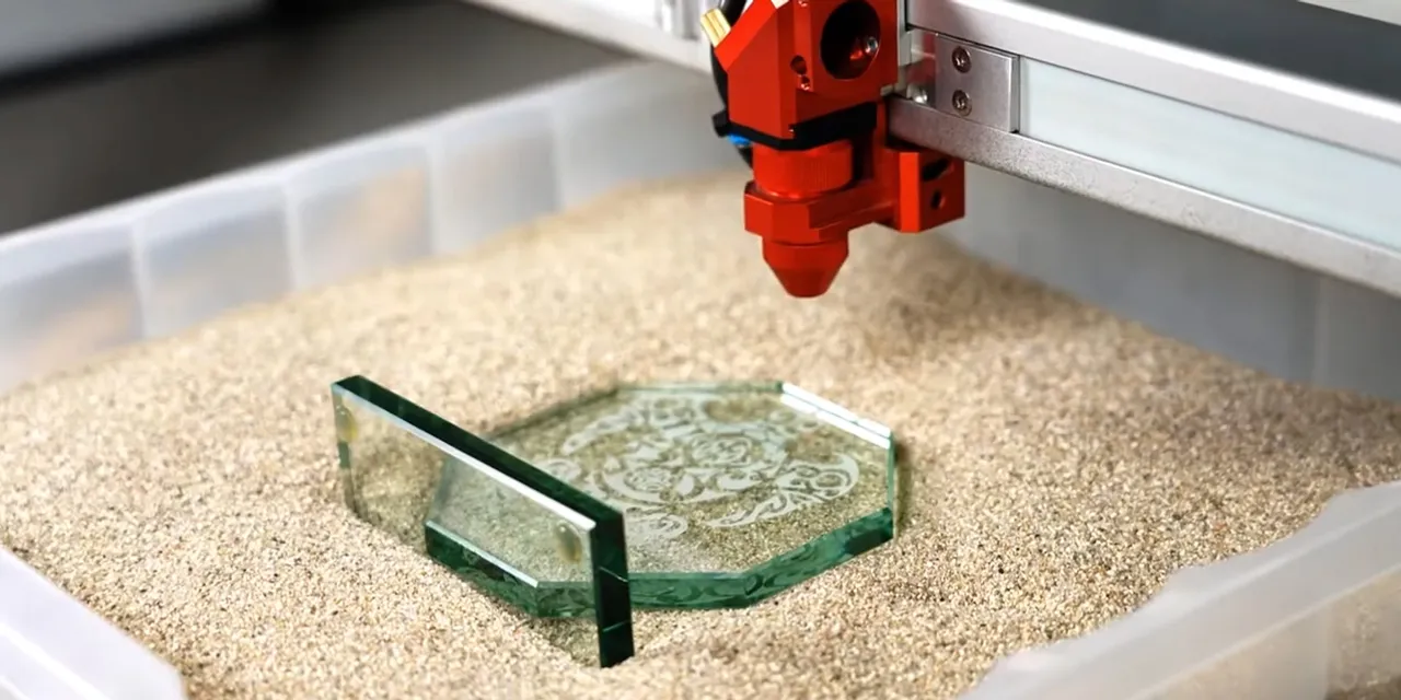 Trotec laser cutter engraving intricate design on glass plate using CO₂ laser technology