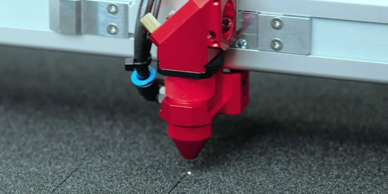 Trotec laser cutter head engraving black foam with precision CO₂ laser technology