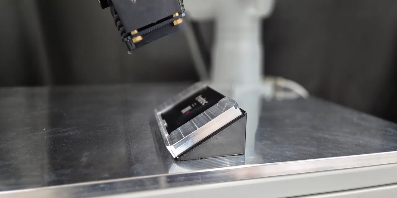 Trotec laser marking machine etching on angled metal part for industrial use