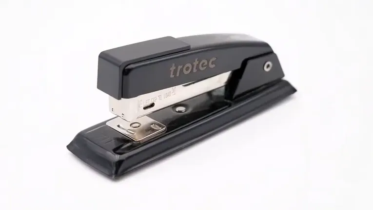 Black stapler with Trotec laser marking engraved on the metal surface