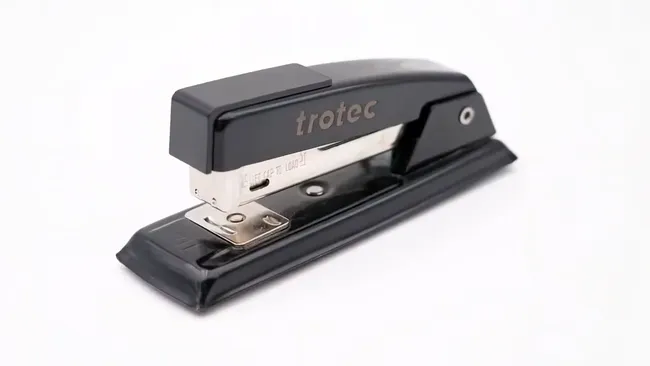 Black stapler with Trotec laser marking engraved on the metal surface