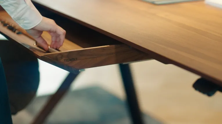 Hand pulling open engraved TEAM 7 wooden drawer made with Trotec laser engraver